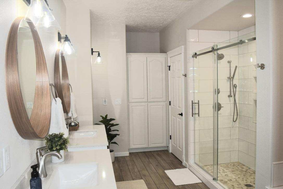 Completed bathroom with glass shower and double vanity