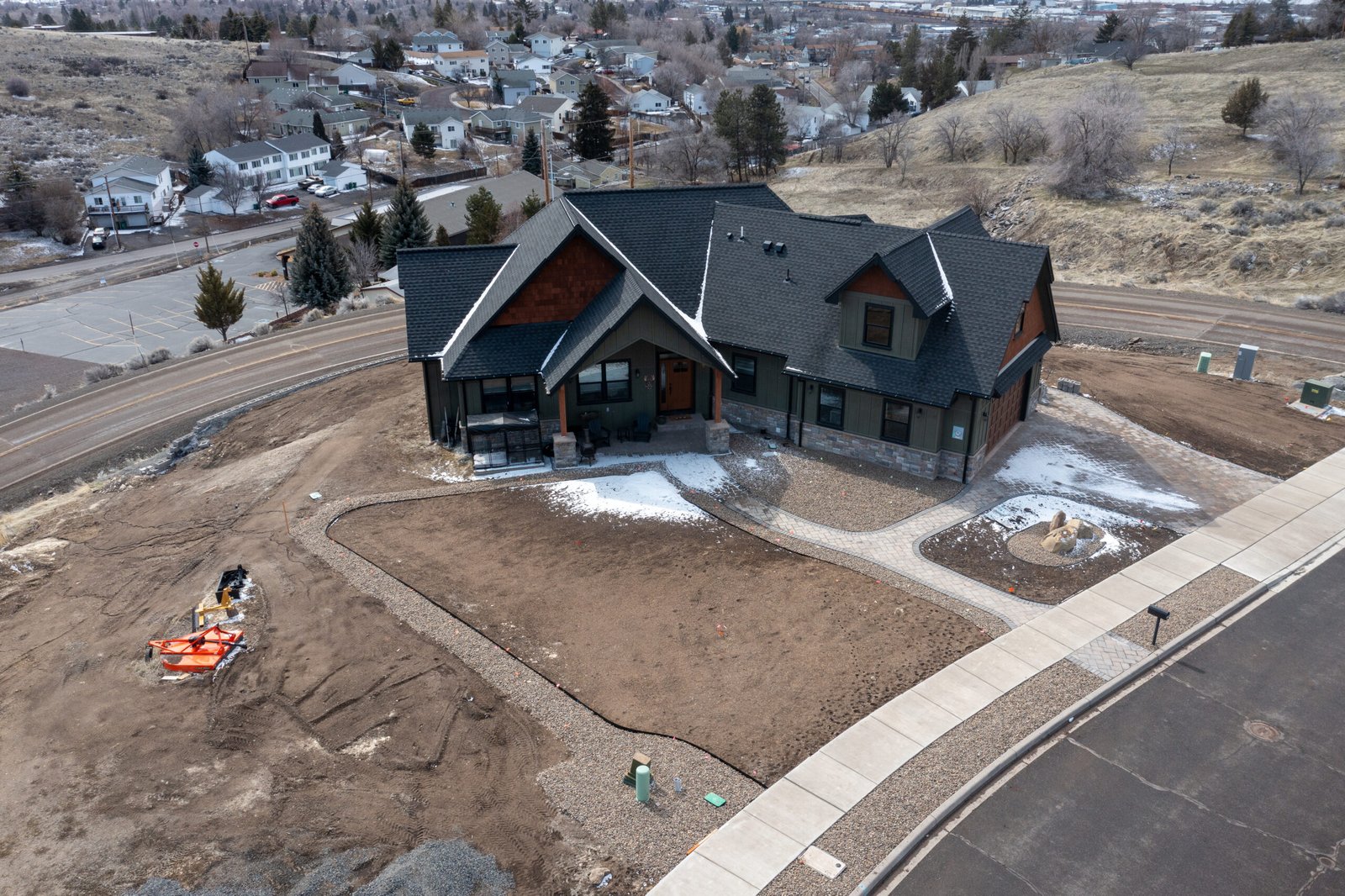Aerial view of the finished craftsman home and driveway