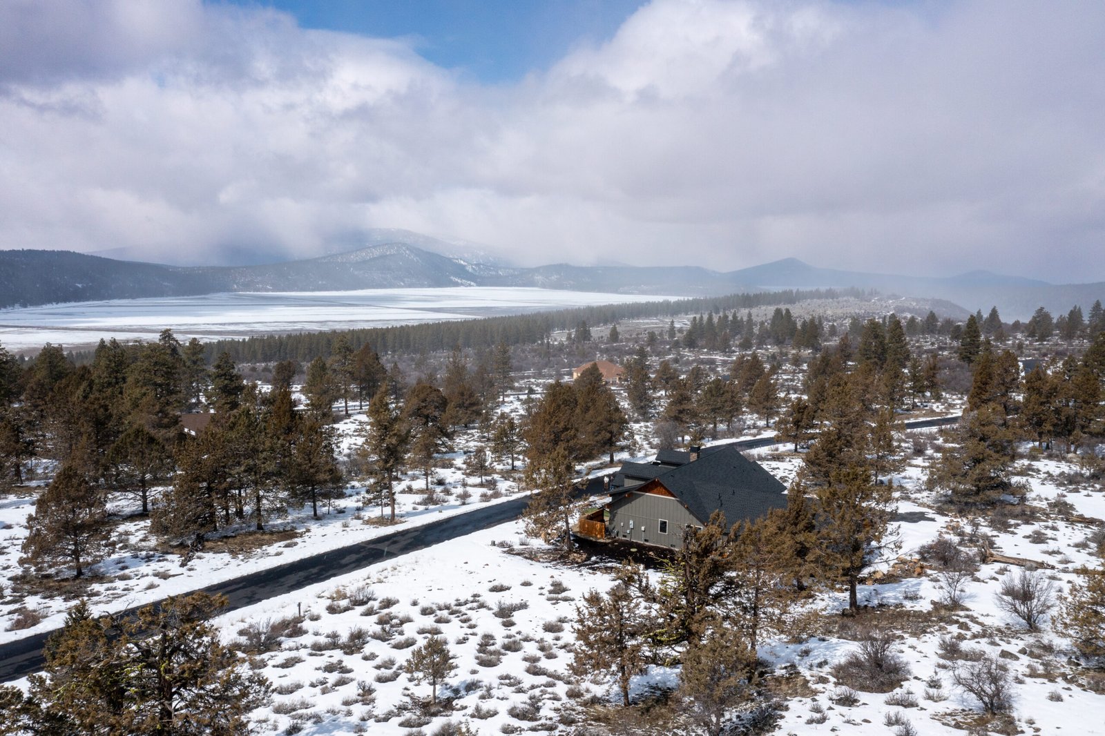 Wide aerial view of the snowy Ridgewater property