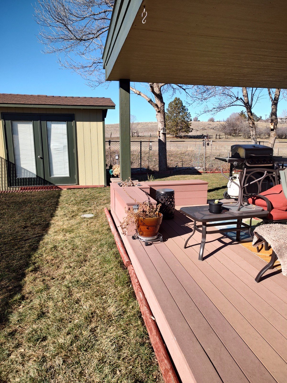 Covered outdoor deck beside the enclosed porch