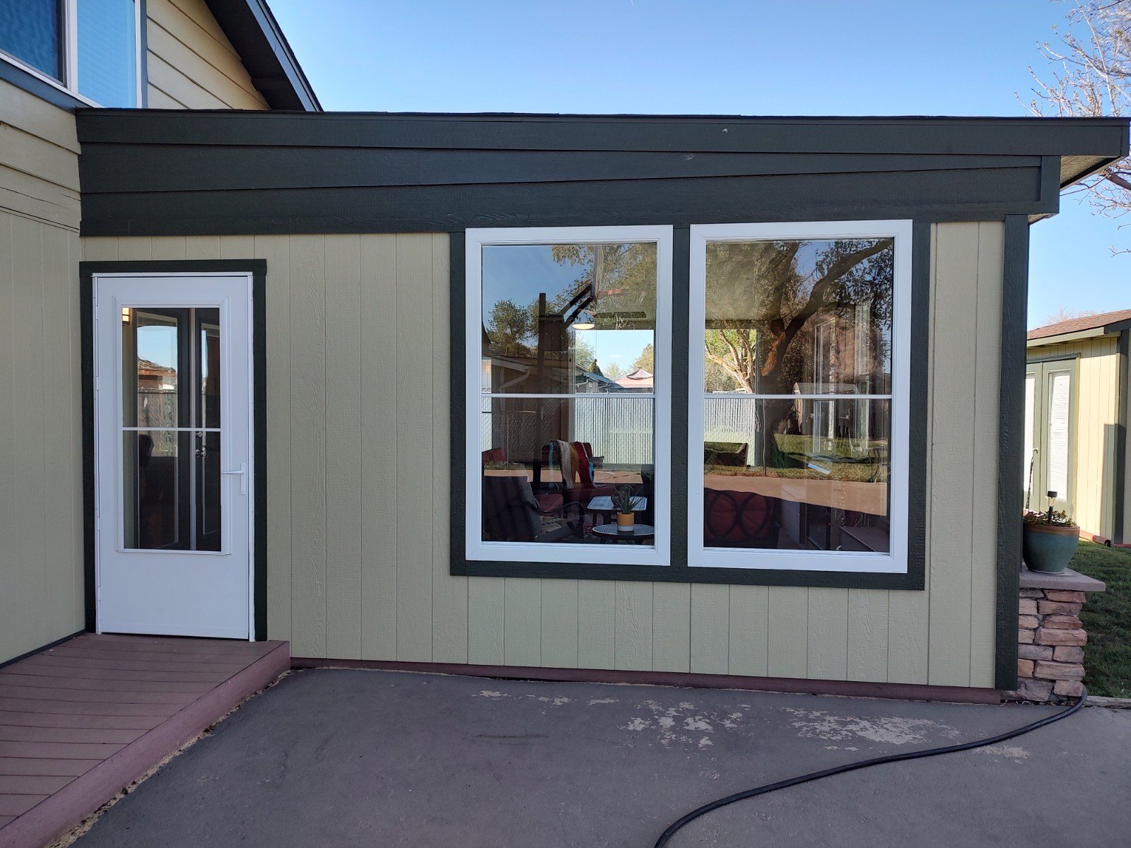 Exterior of the enclosed porch with door and windows