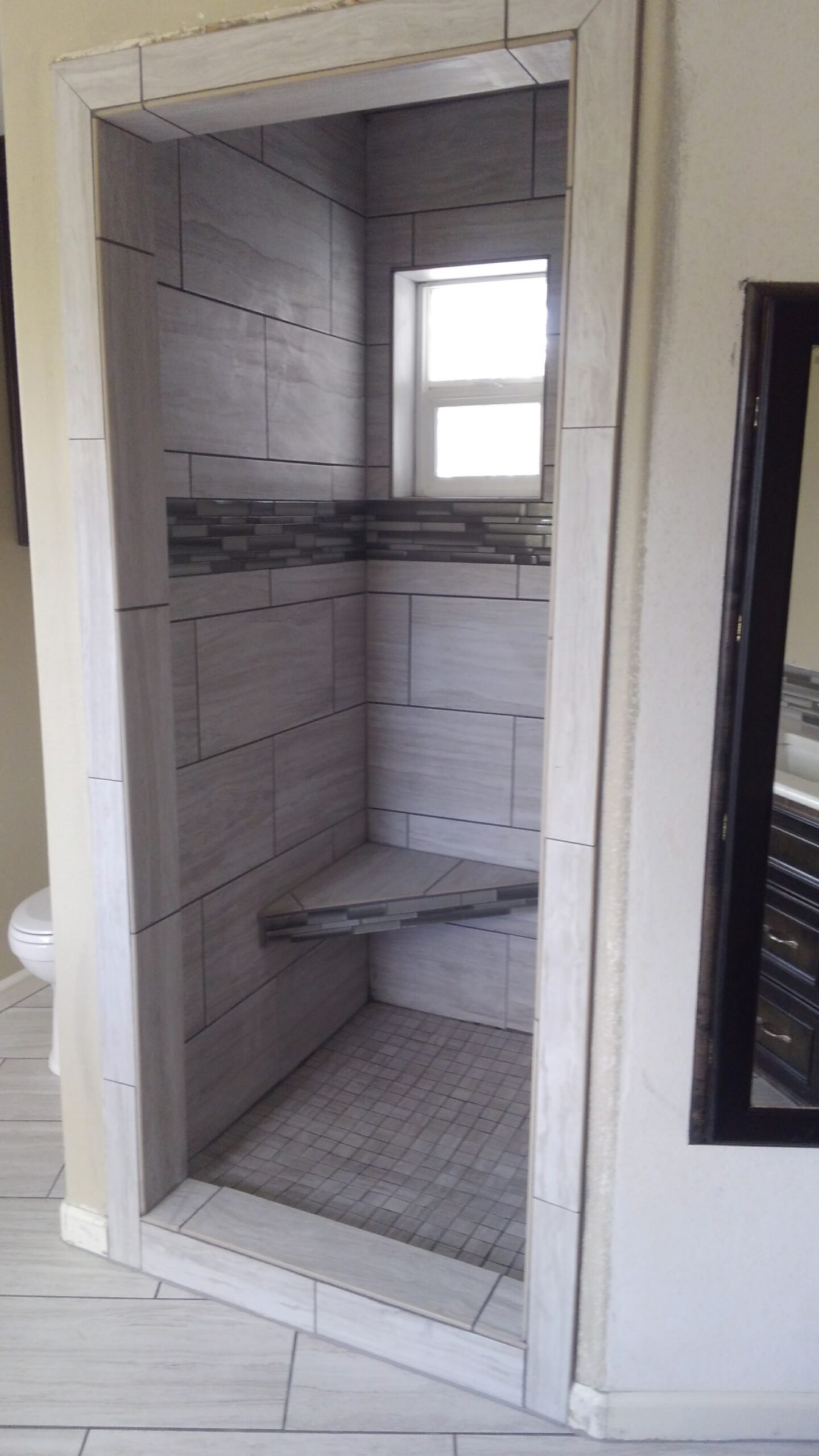 Tiled walk-in shower in the renovated bathroom